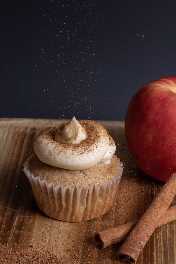 vertical-view-cupcake-with-frosting-while-sprinkling-coffee-powder-top (1)