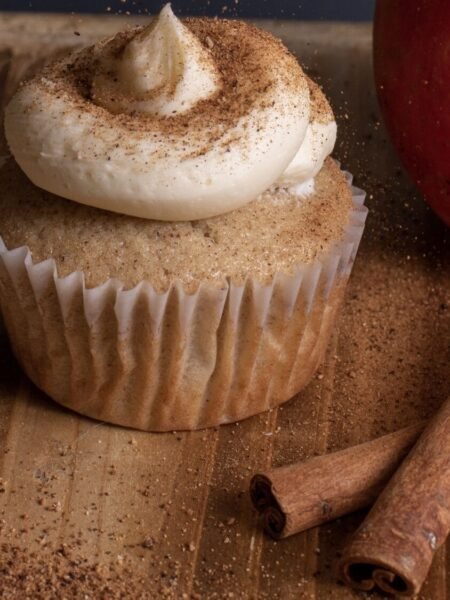 vertical-view-cupcake-with-frosting-while-sprinkling-coffee-powder-top (1)